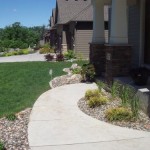 Front yard chilton edging border, river rock and plantings