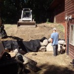 Lower boulder wall installation - Wolf Landscaping