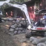 Installing boulder steps - Wolf Landscaping