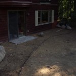 Boulder outcroppings, edging, mulch and paver pad completed