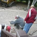 Cutting the pavers to finishe the outer patio - Wolf Landscaping