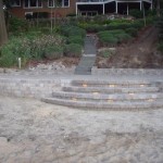 Lights, pavers and walls complete by Wolf Landscaping